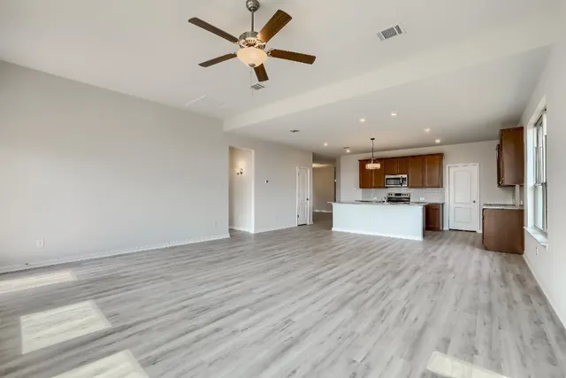 a view of kitchen with a sink cabinets and wooden floor