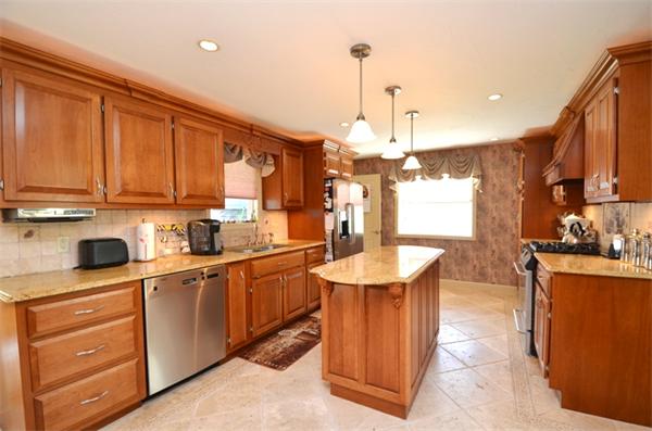 150 Dunstable Road Chelmsford, MA 01863 - Photo 2 of 30 a kitchen with stainless steel appliances granite countertop a sink a stove and a wooden floors