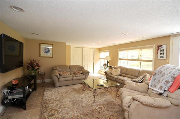 150 Dunstable Road Chelmsford, MA 01863 - Photo 23 of 30 a living room with furniture and a flat screen tv