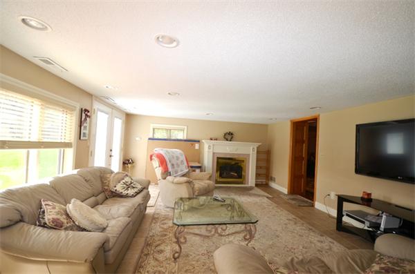 150 Dunstable Road Chelmsford, MA 01863 - Photo 24 of 30 a living room with furniture a flat screen tv and a fireplace