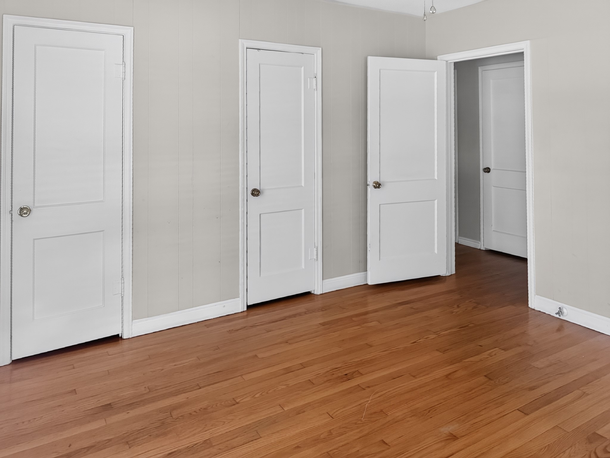2313 Avenue L Rosenberg, TX 77471 - Photo 15 of 31 Alternate view of the bedroom highlighting hardwood floors, dual closets, and convenient access to the hallway.