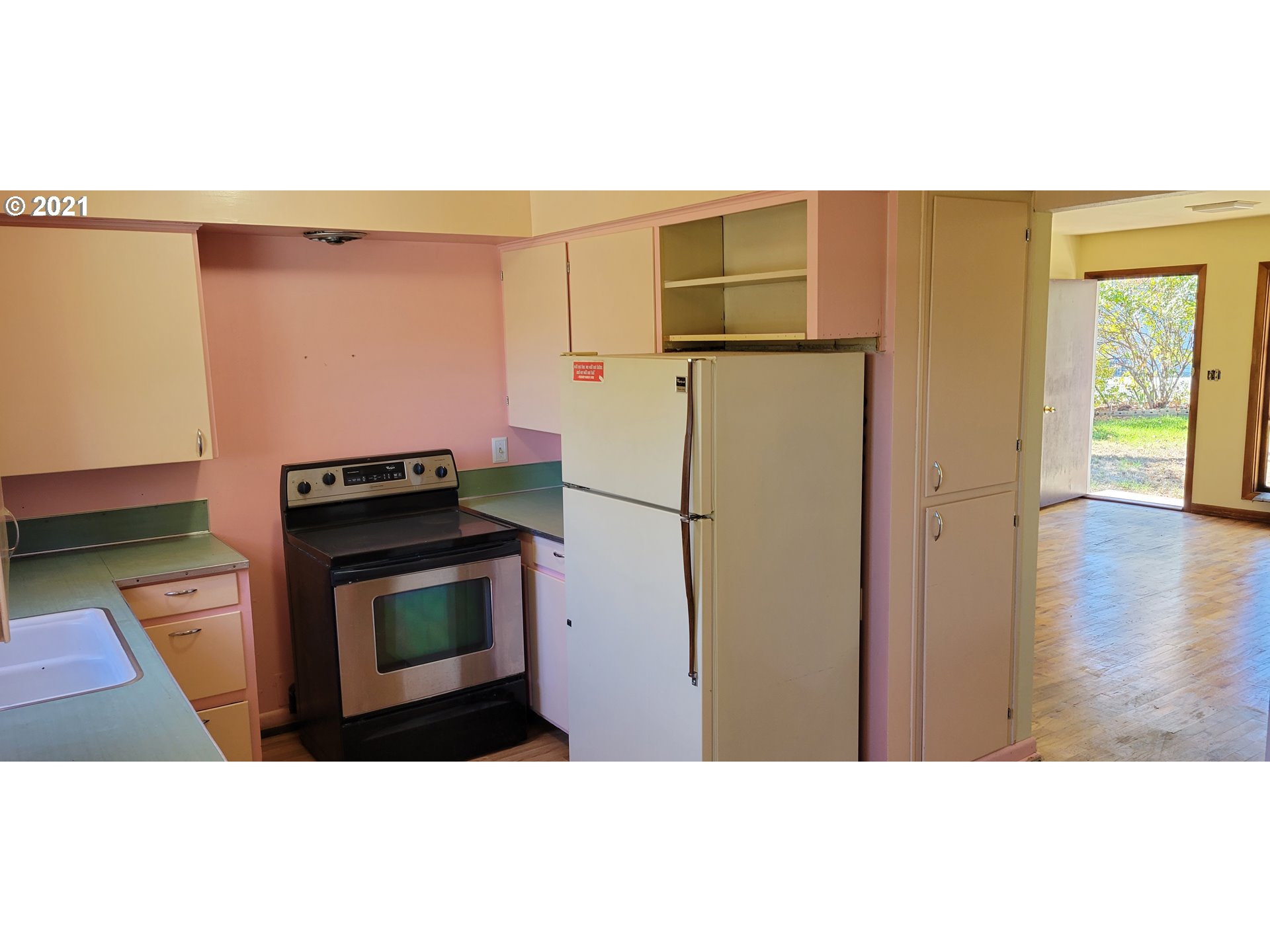 421 Smith Street Riddle, OR 97469 - Photo 11 of 14 a kitchen with stainless steel appliances a refrigerator stove and microwave