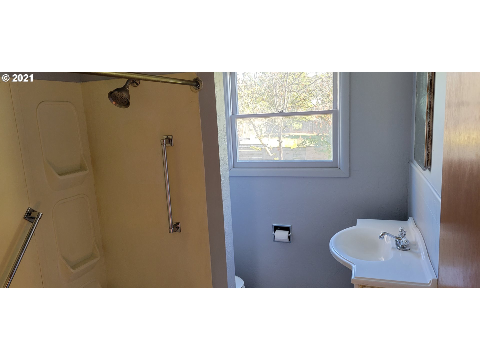 421 Smith Street Riddle, OR 97469 - Photo 8 of 14 a bathroom with a toilet sink and window