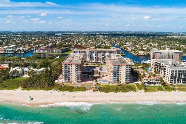an aerial view of a house with a yard basket ball court and outdoor seating
