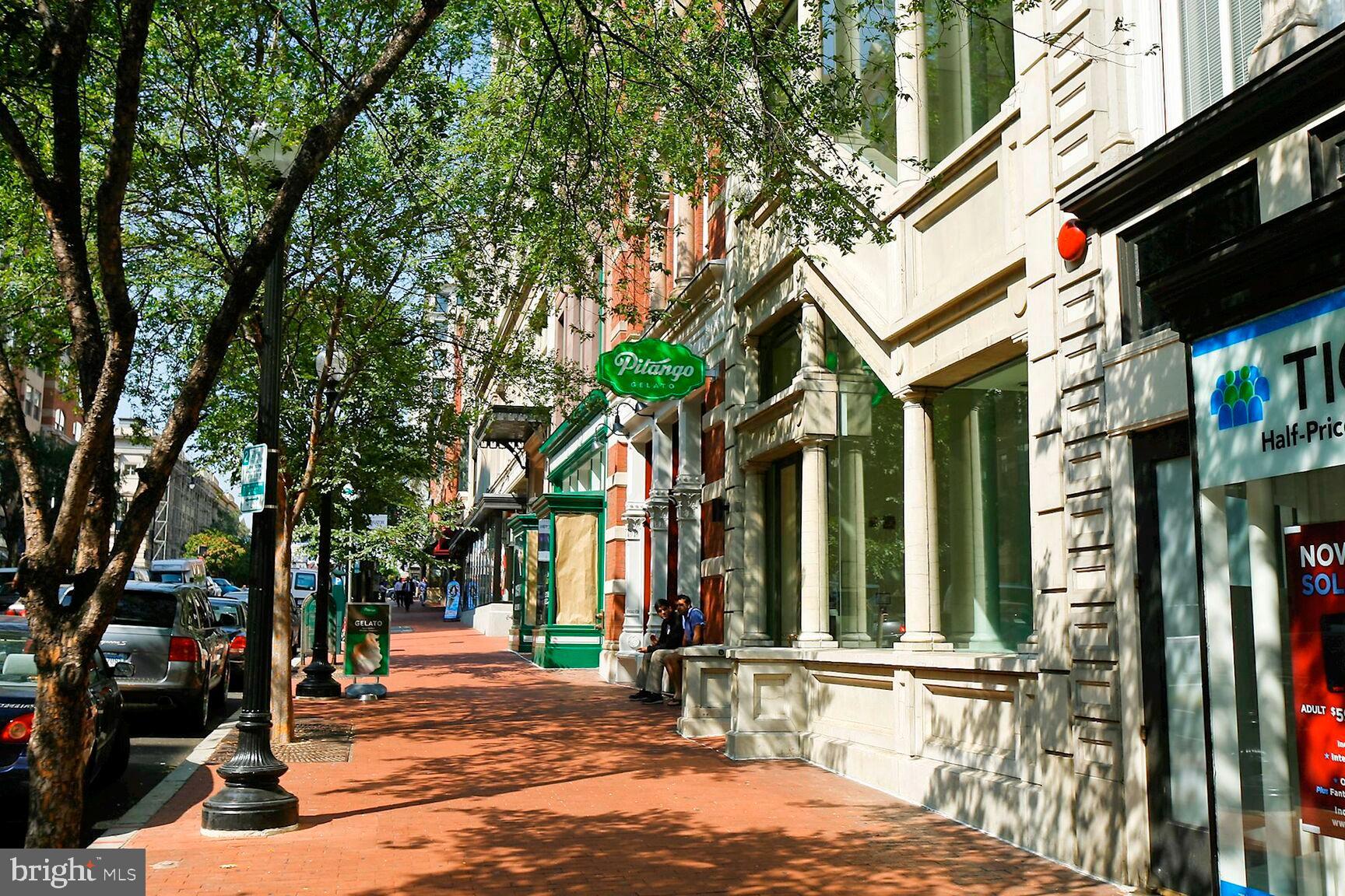 616 E Street Northwest, Unit 807 Washington, DC 20004 - Photo 22 of 24 a view of a brick house with large windows and a table and chairs