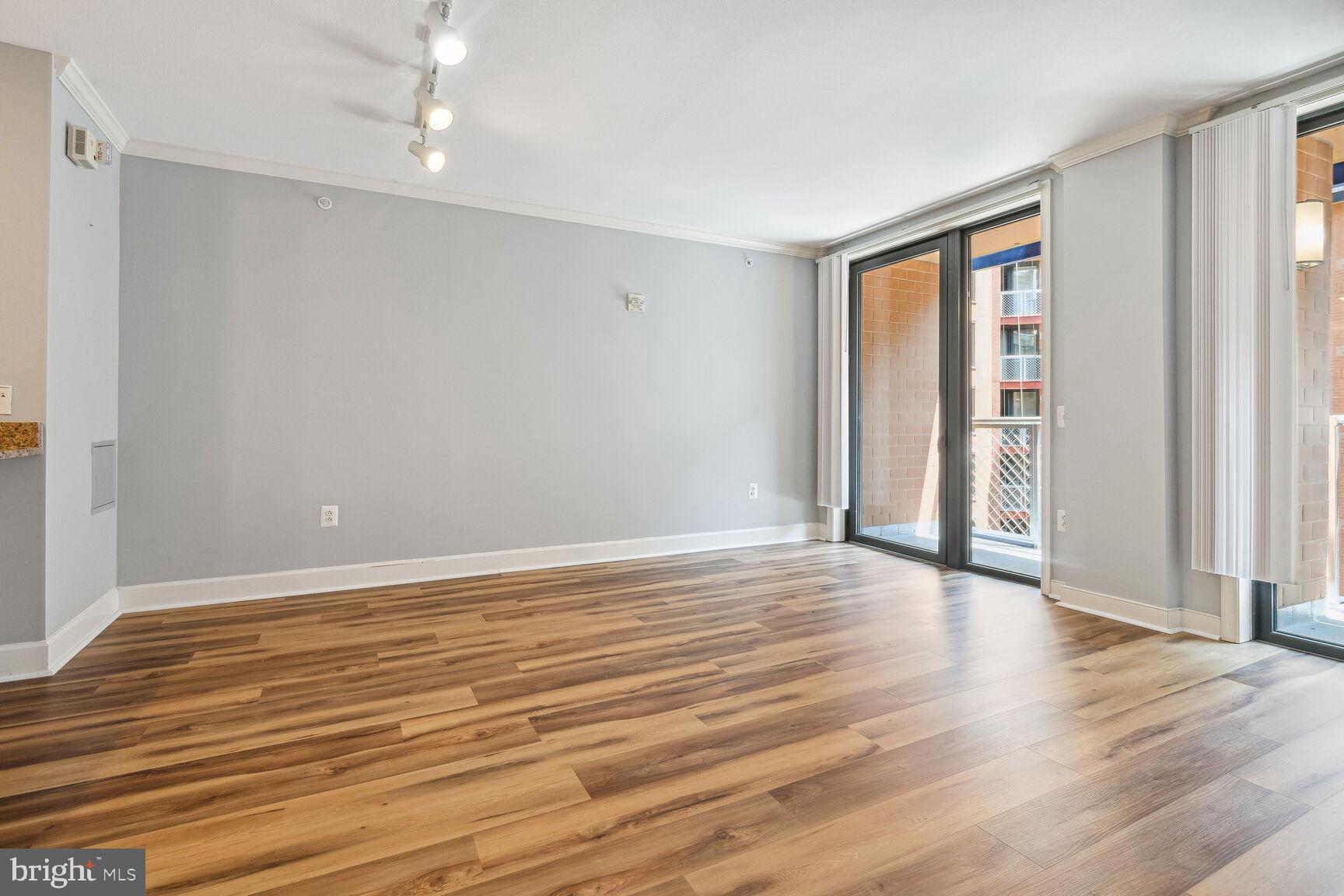 616 E Street Northwest, Unit 807 Washington, DC 20004 - Photo 3 of 24 wooden floor in an empty room with a window