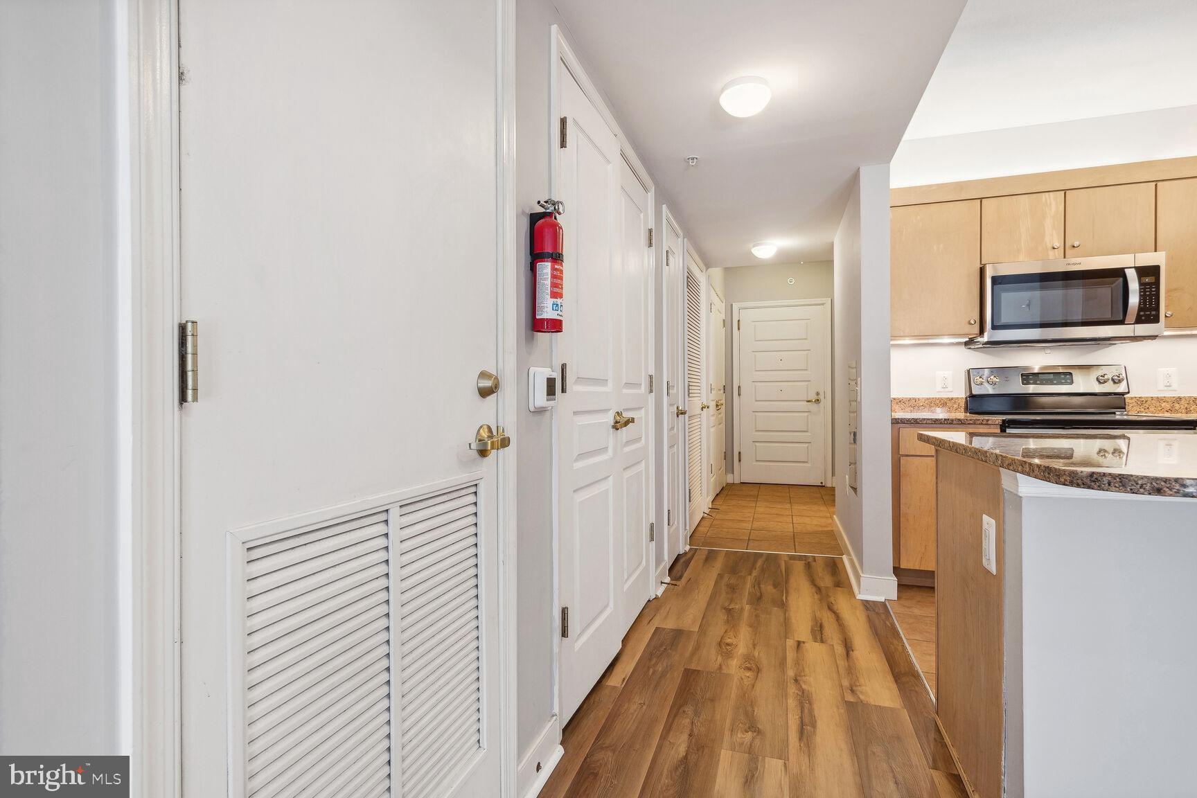 616 E Street Northwest, Unit 807 Washington, DC 20004 - Photo 4 of 24 a view of a kitchen from the hallway