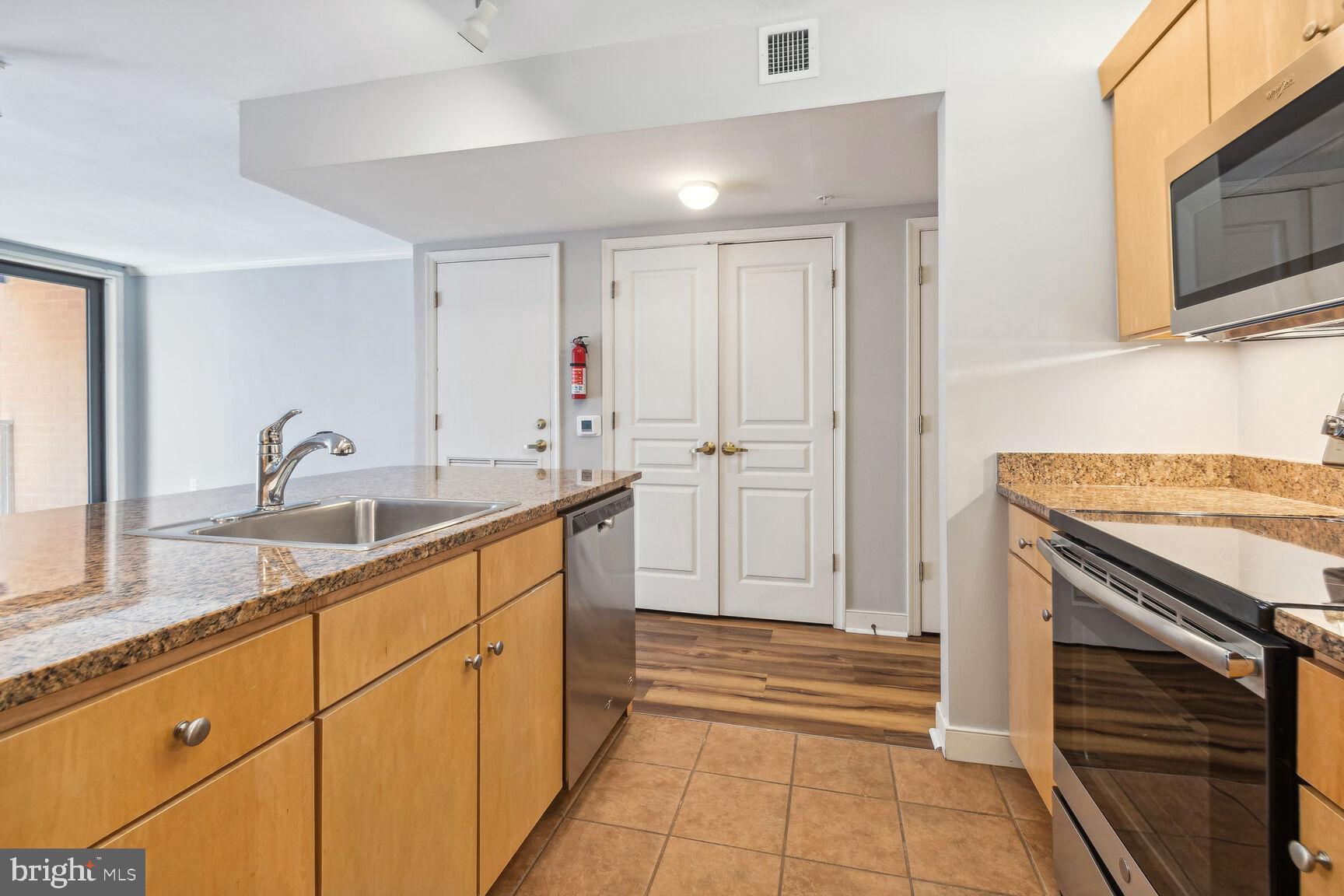 616 E Street Northwest, Unit 807 Washington, DC 20004 - Photo 8 of 24 a kitchen with a sink and cabinets
