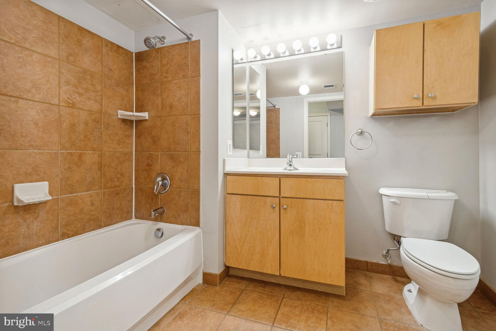 616 E Street Northwest, Unit 807 Washington, DC 20004 - Photo 10 of 24 a bathroom with a sink a toilet and shower