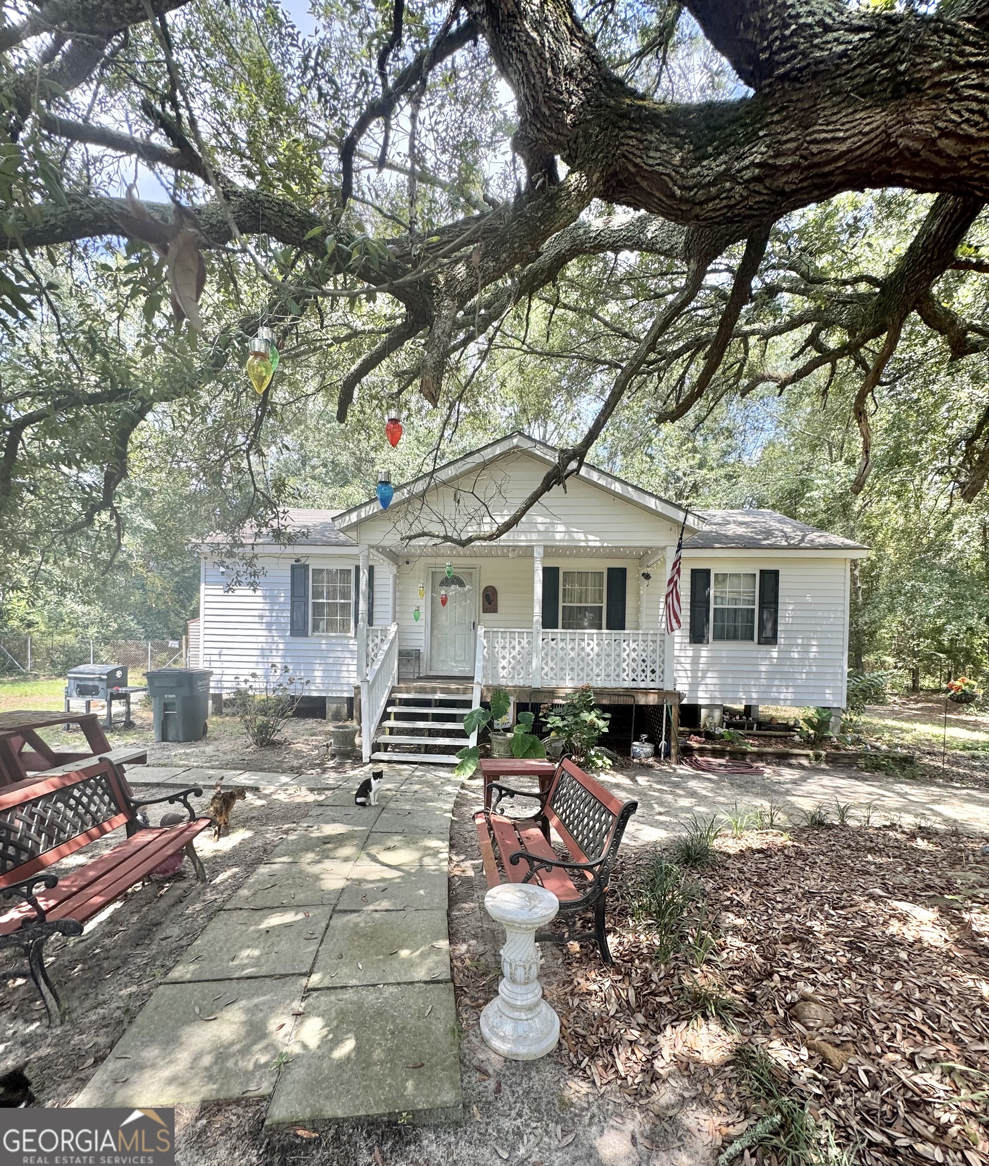 a front view of a house with yard and green space