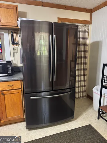 a metallic refrigerator freezer sitting in a kitchen