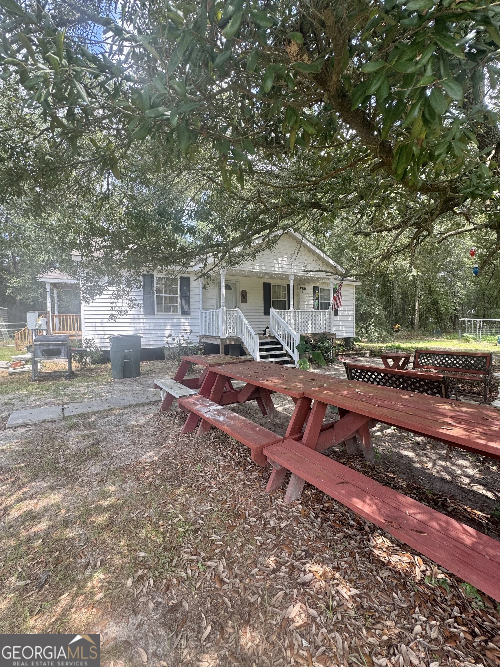 75 Rudolph Road Collins, GA 30421 - Photo 2 of 15 a front view of a house with garden