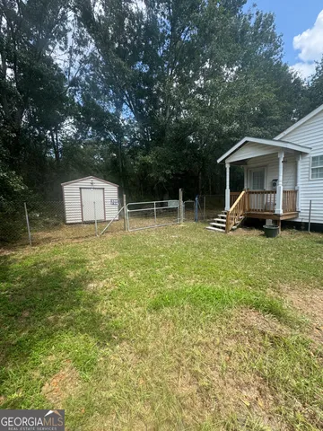 a backyard of a house with yard and trampoline