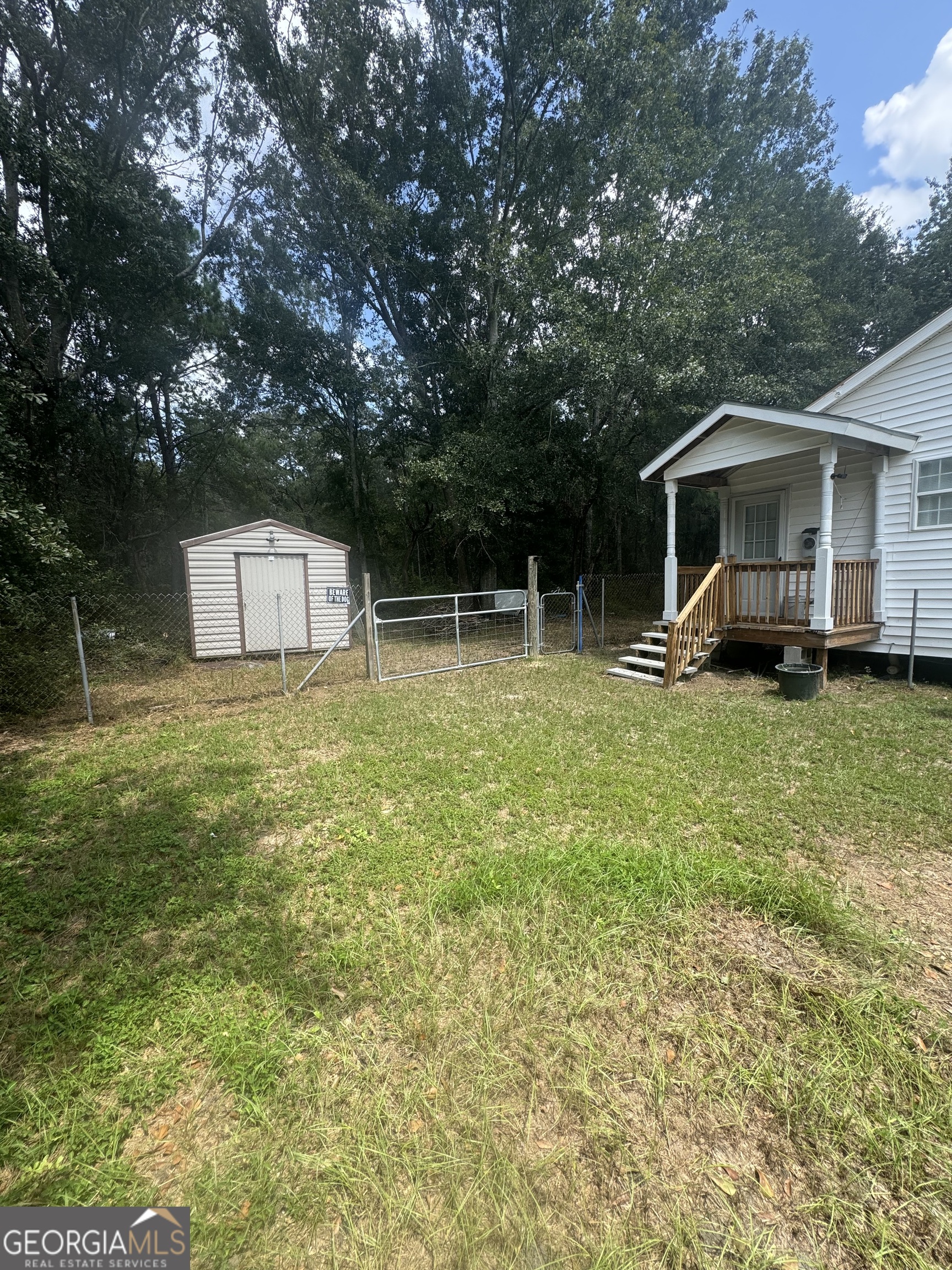 75 Rudolph Road Collins, GA 30421 - Photo 3 of 15 a backyard of a house with yard and trampoline