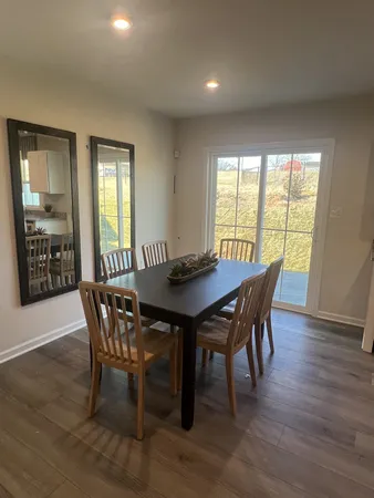 a kitchen with a table chairs refrigerator microwave and cabinets