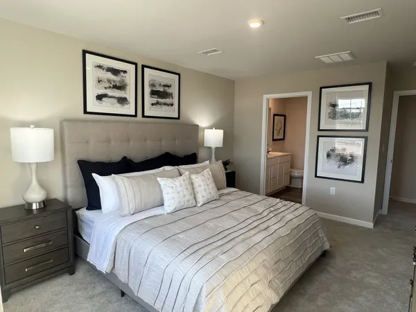 a bedroom with a bed and a lamp