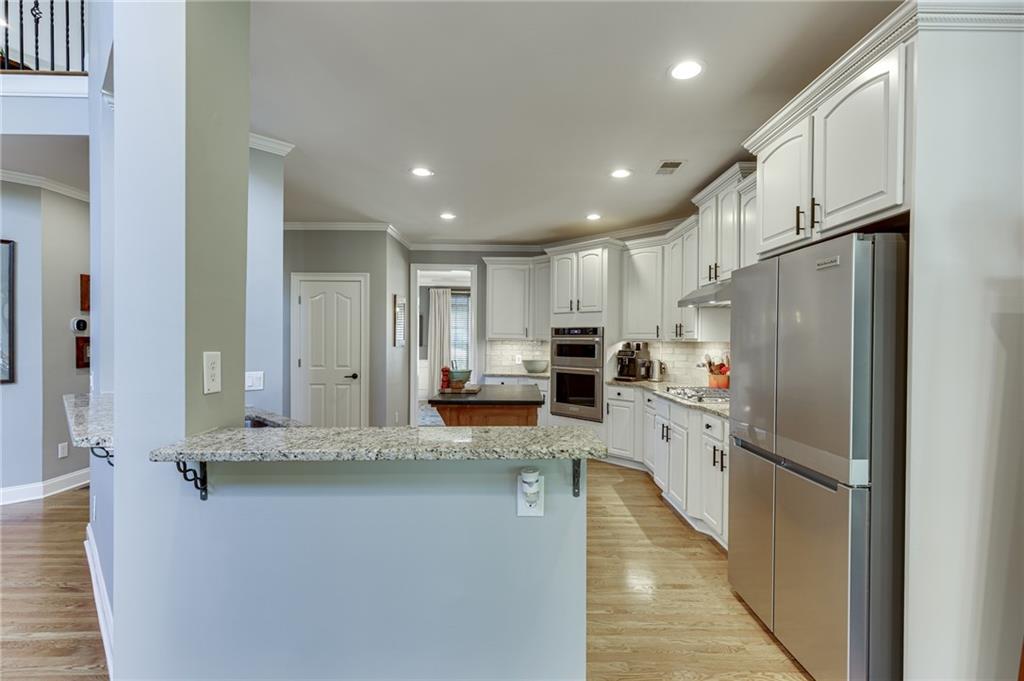 2758 Pathview Drive Dacula, GA 30019 - Photo 13 of 48 a kitchen with stainless steel appliances a refrigerator sink and cabinets