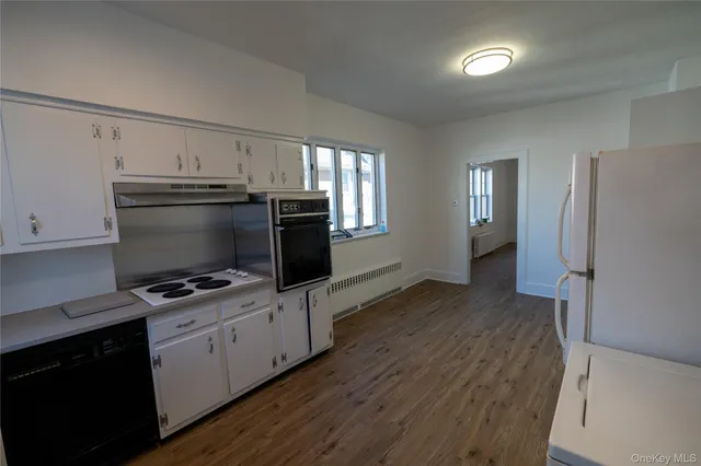 a kitchen with a refrigerator and a stove top oven