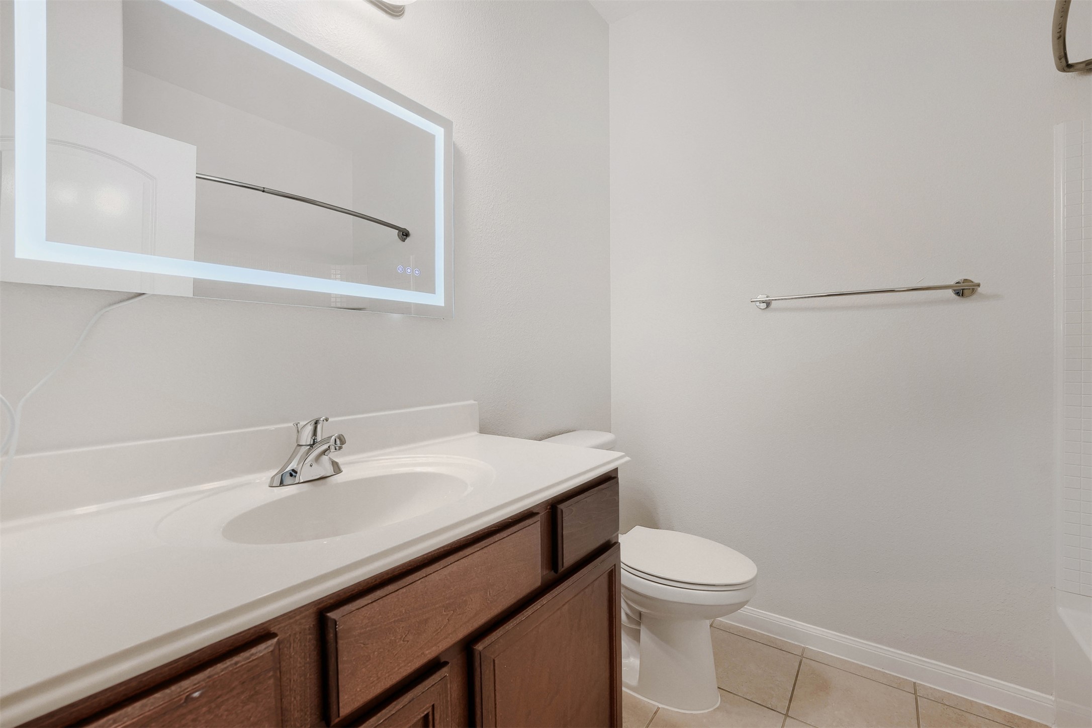 13408 Clara Martin Road Manor, TX 78653 - Photo 24 of 27 a bathroom with a sink a toilet and mirror