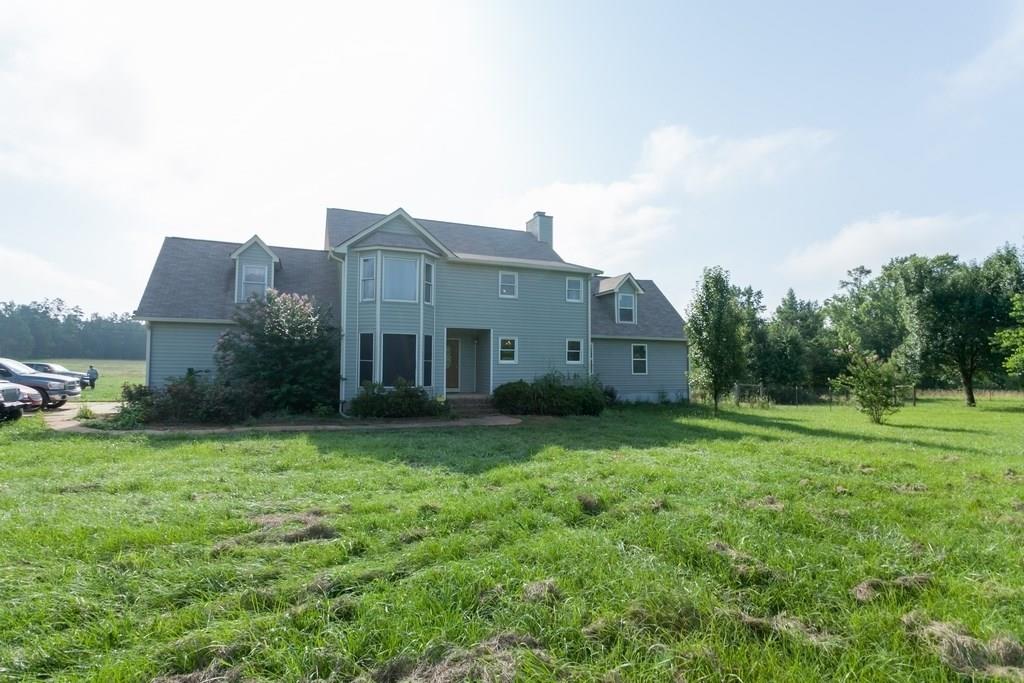1270 Weaver Jones Road Rutledge, GA 30663 - Photo 1 of 1 a view of a house with a big yard potted plants and large trees