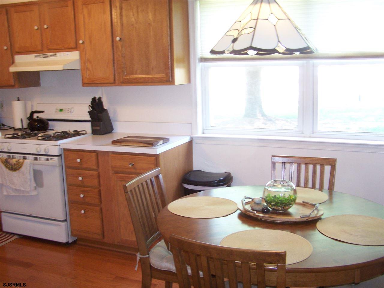 a kitchen with a table and chairs in it