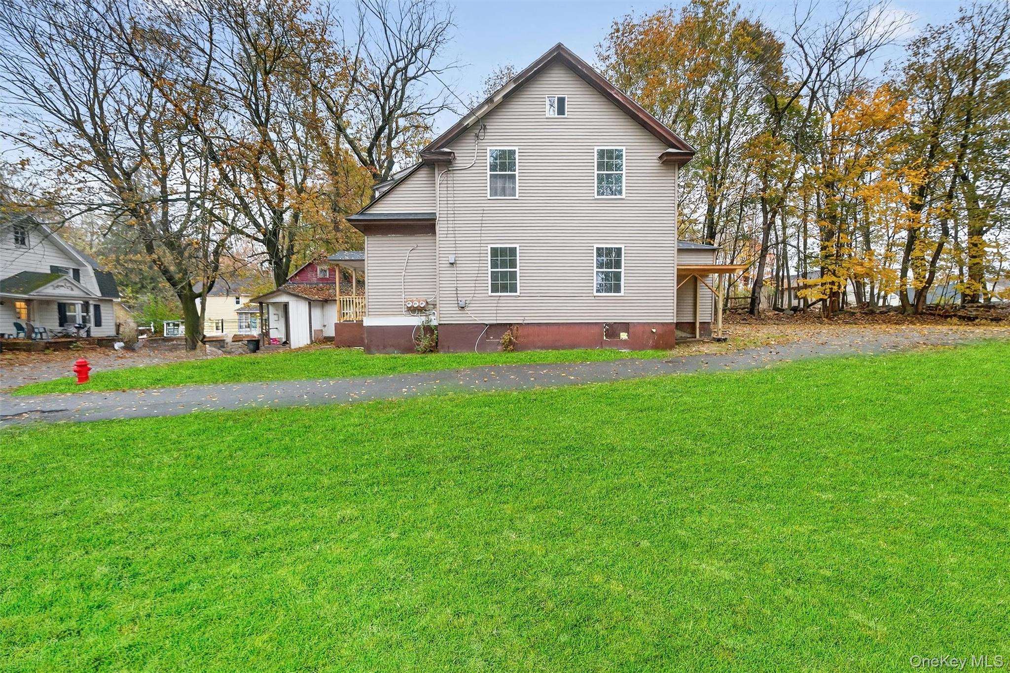8 Cottage St Extension Monticello, NY 12701 - Photo 21 of 23 View of side of property featuring a lawn