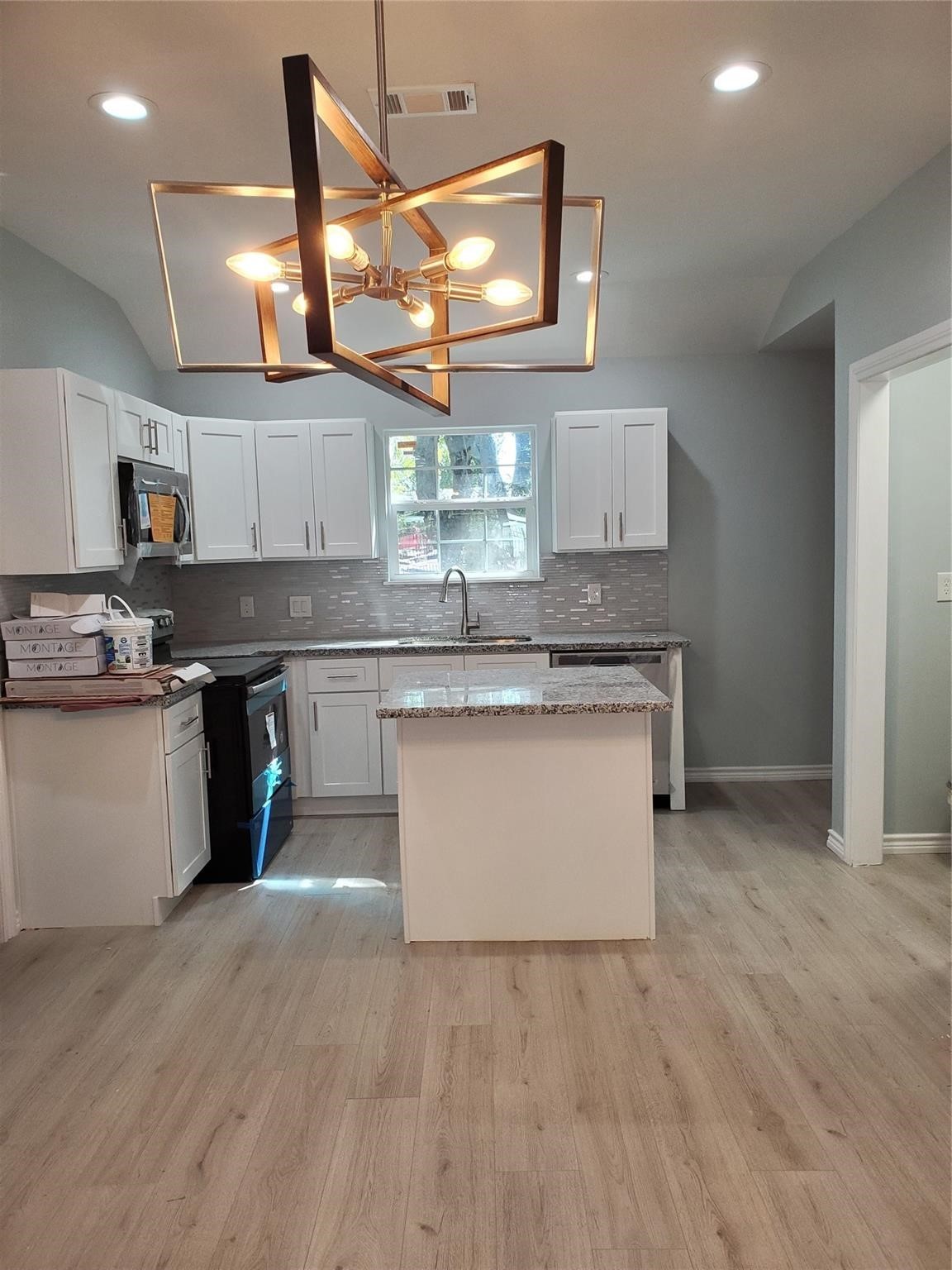 6815 Sidney Street Houston, TX 77021 - Photo 2 of 14 a kitchen with stainless steel appliances granite countertop a stove a sink and a microwave