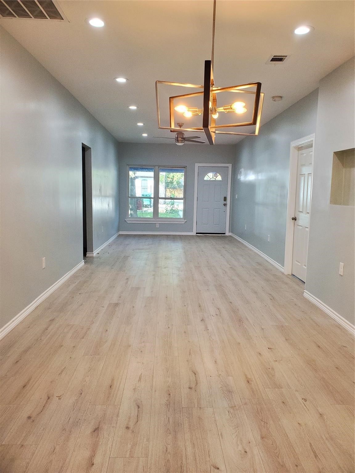 6815 Sidney Street Houston, TX 77021 - Photo 8 of 14 a view of an empty room with window and wooden floor