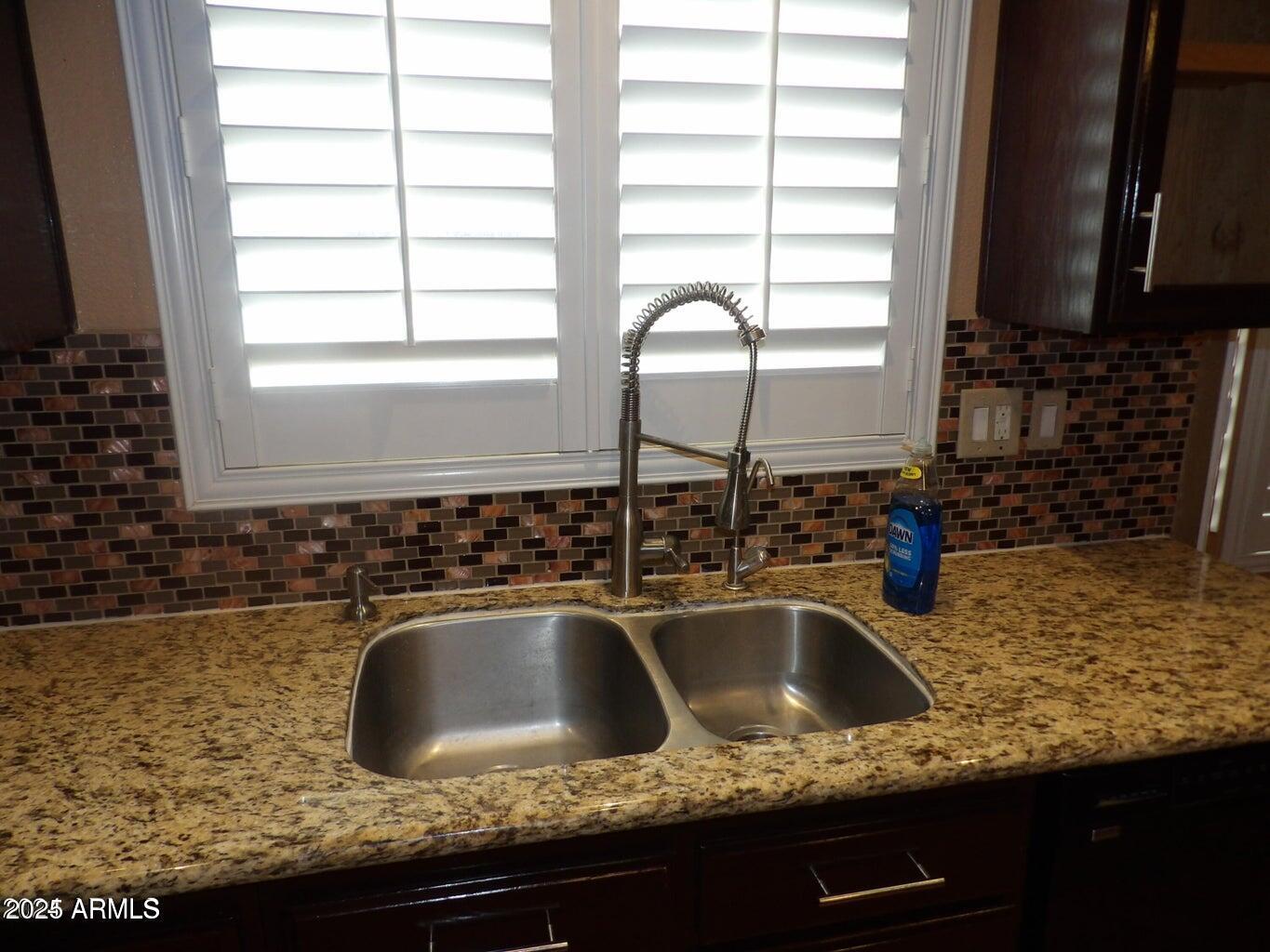 8221 West Papago Street Phoenix, AZ 85043 - Photo 12 of 20 a kitchen with granite countertop a sink and a window