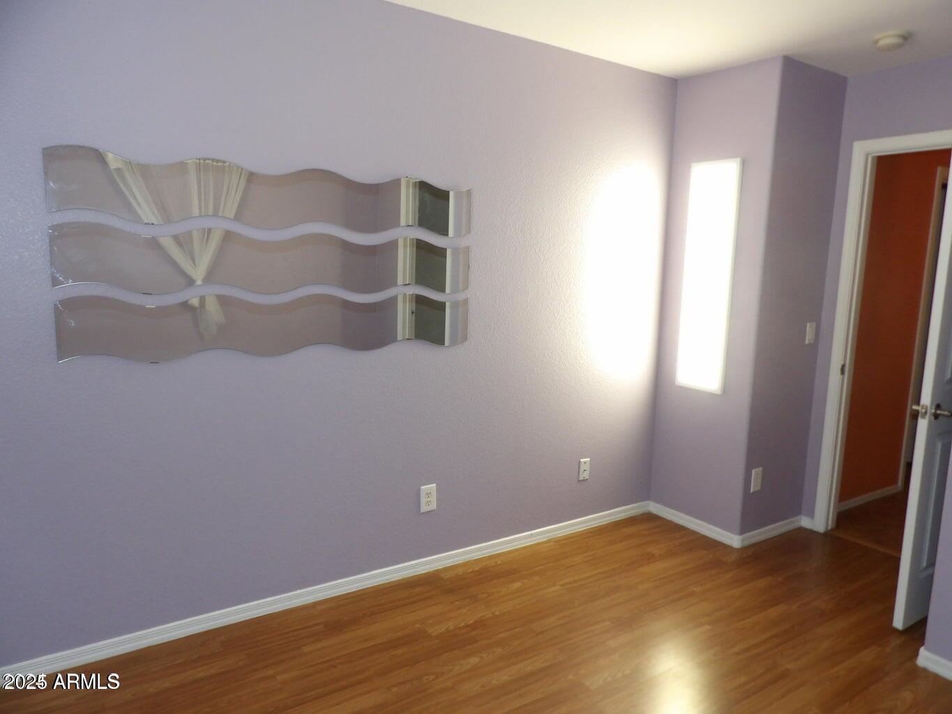 8221 West Papago Street Phoenix, AZ 85043 - Photo 2 of 20 an empty room with wooden floor and windows