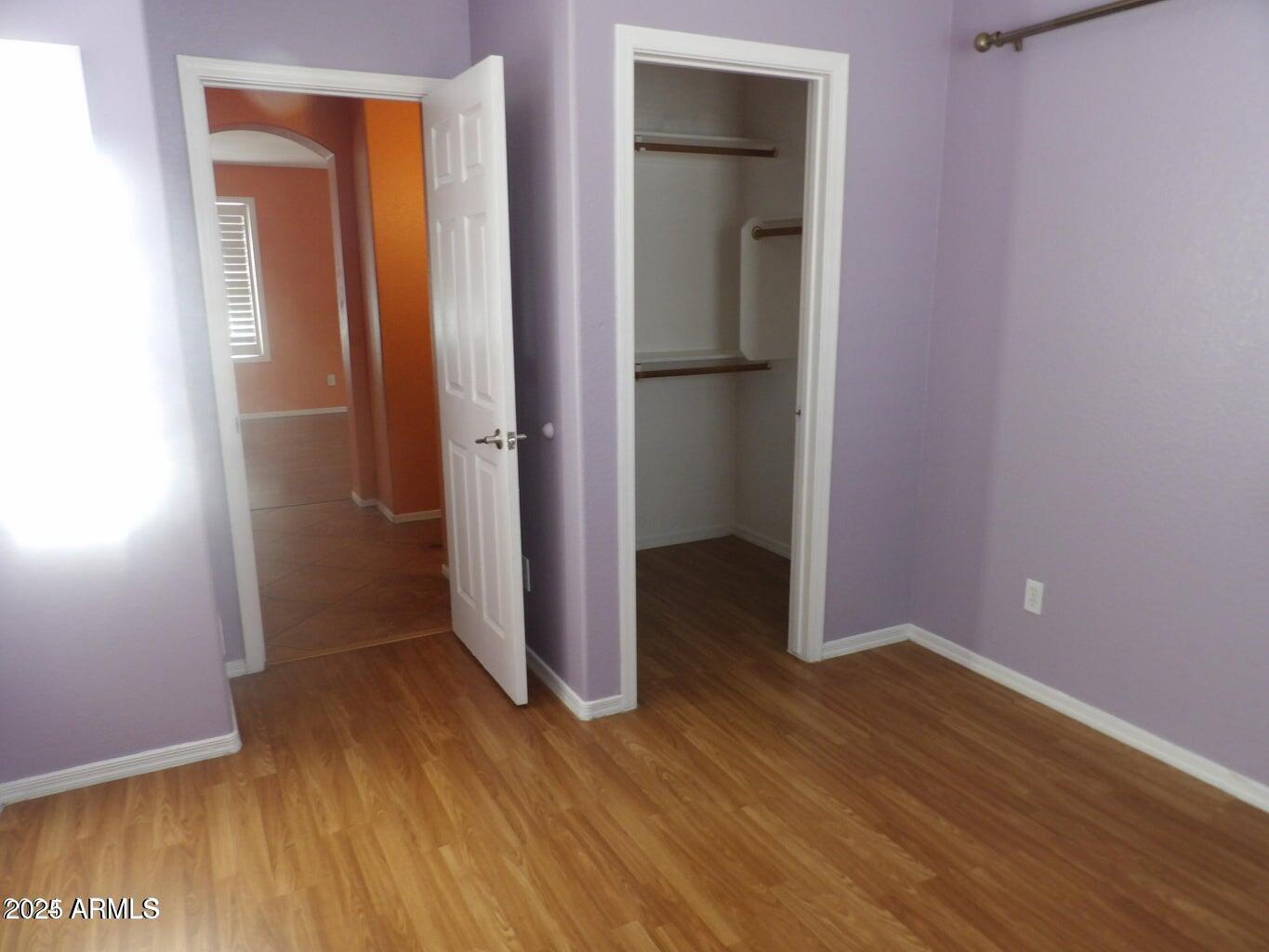 8221 West Papago Street Phoenix, AZ 85043 - Photo 3 of 20 an empty room with wooden floor and closet