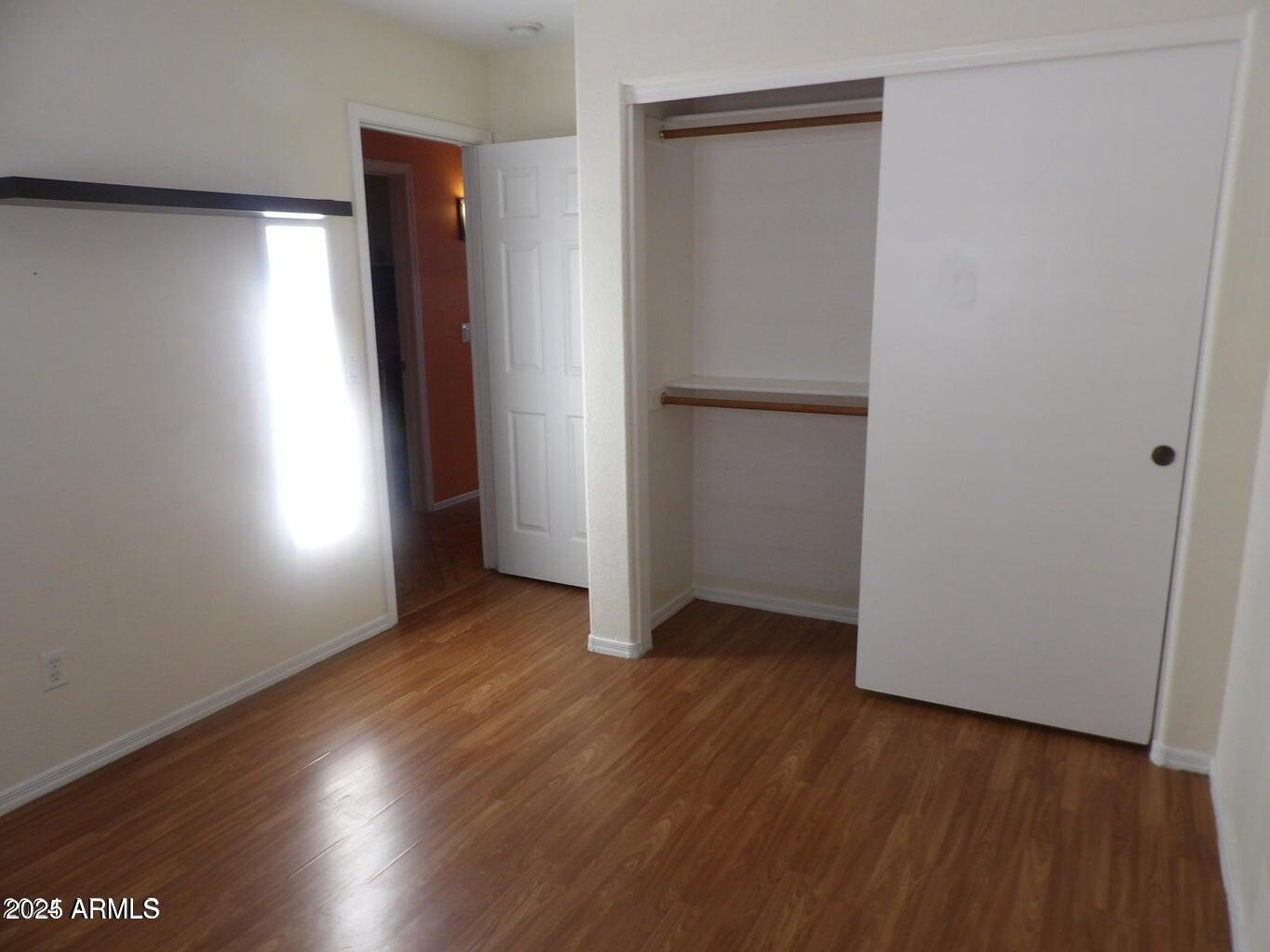 8221 West Papago Street Phoenix, AZ 85043 - Photo 5 of 20 an empty room with wooden floor and windows