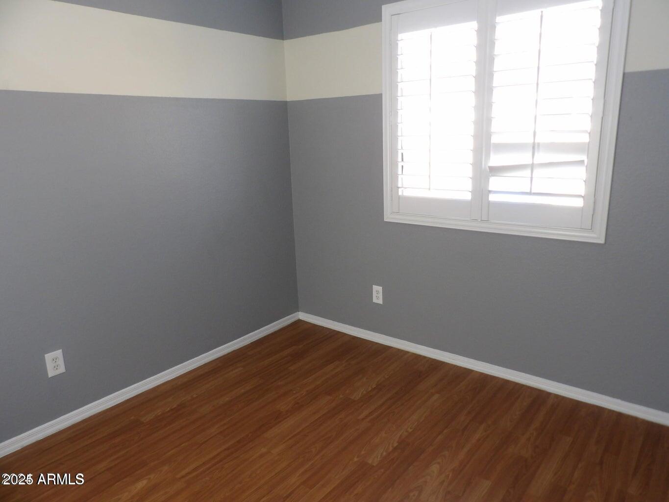 8221 West Papago Street Phoenix, AZ 85043 - Photo 6 of 20 an empty room with wooden floor and windows