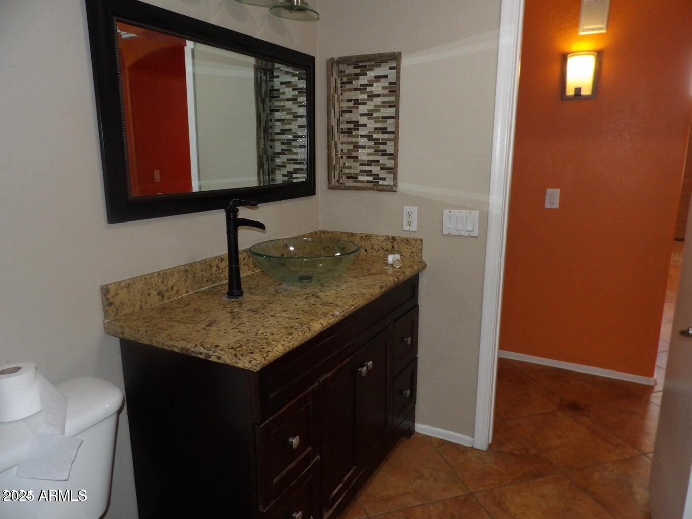 8221 West Papago Street Phoenix, AZ 85043 - Photo 8 of 20 a kitchen with a sink a vanity and mirror