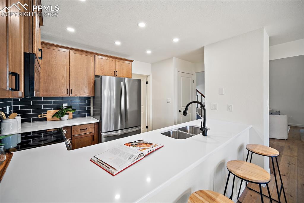 62 Rising Sun Terrace Colorado Springs, CO 80921 - Photo 12 of 46 a kitchen with refrigerator and chairs
