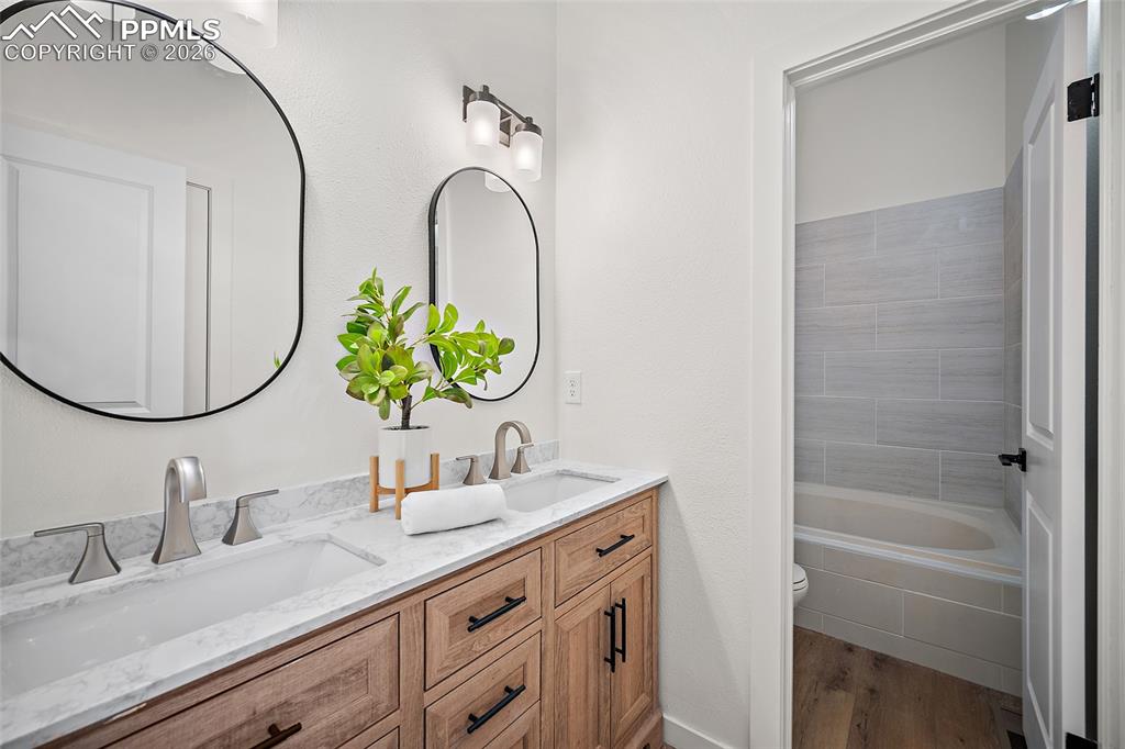 62 Rising Sun Terrace Colorado Springs, CO 80921 - Photo 17 of 46 a bathroom with a granite countertop sink a mirror and a shower