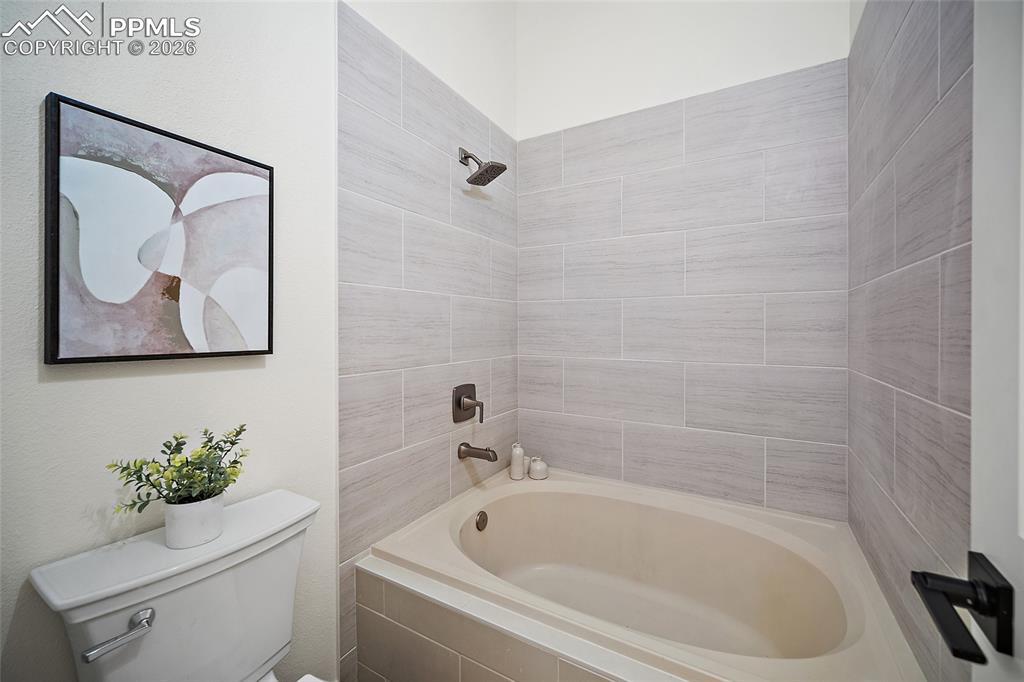 62 Rising Sun Terrace Colorado Springs, CO 80921 - Photo 18 of 46 a bath tub sitting next to a white toilet and sink