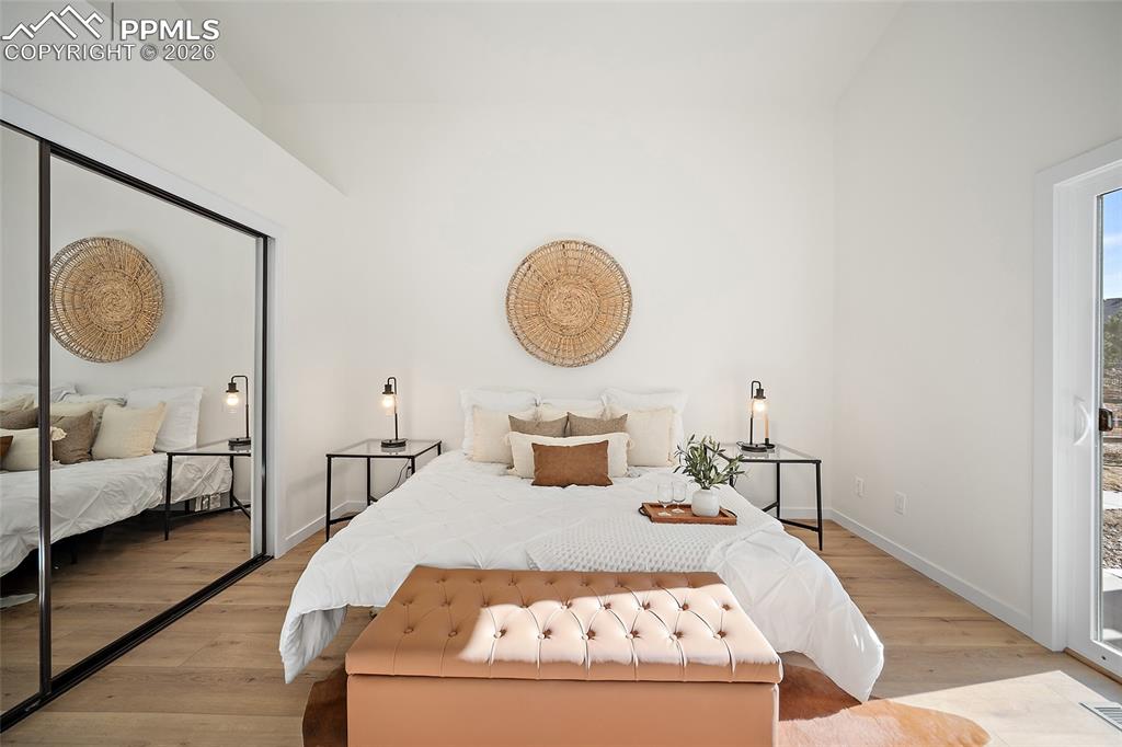 62 Rising Sun Terrace Colorado Springs, CO 80921 - Photo 20 of 46 a bedroom with bed and a chandelier