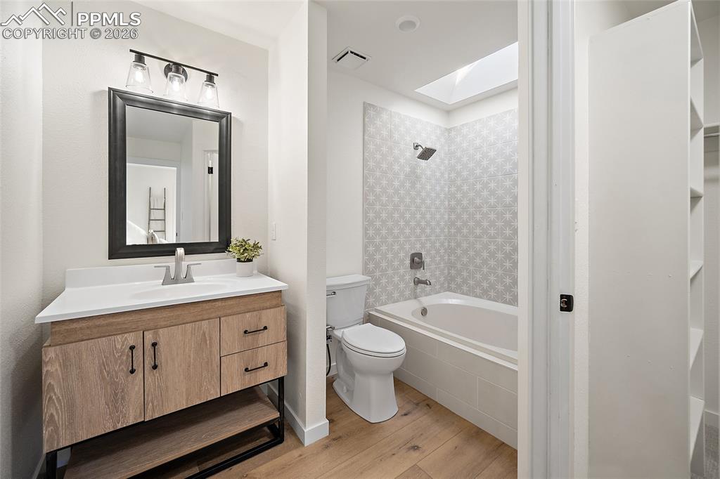 62 Rising Sun Terrace Colorado Springs, CO 80921 - Photo 25 of 46 a bathroom with a granite countertop sink a toilet mirror and bathtub