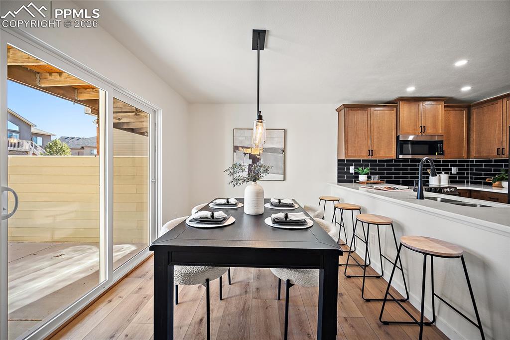 62 Rising Sun Terrace Colorado Springs, CO 80921 - Photo 10 of 46 a kitchen with stainless steel appliances a dining table chairs and couches