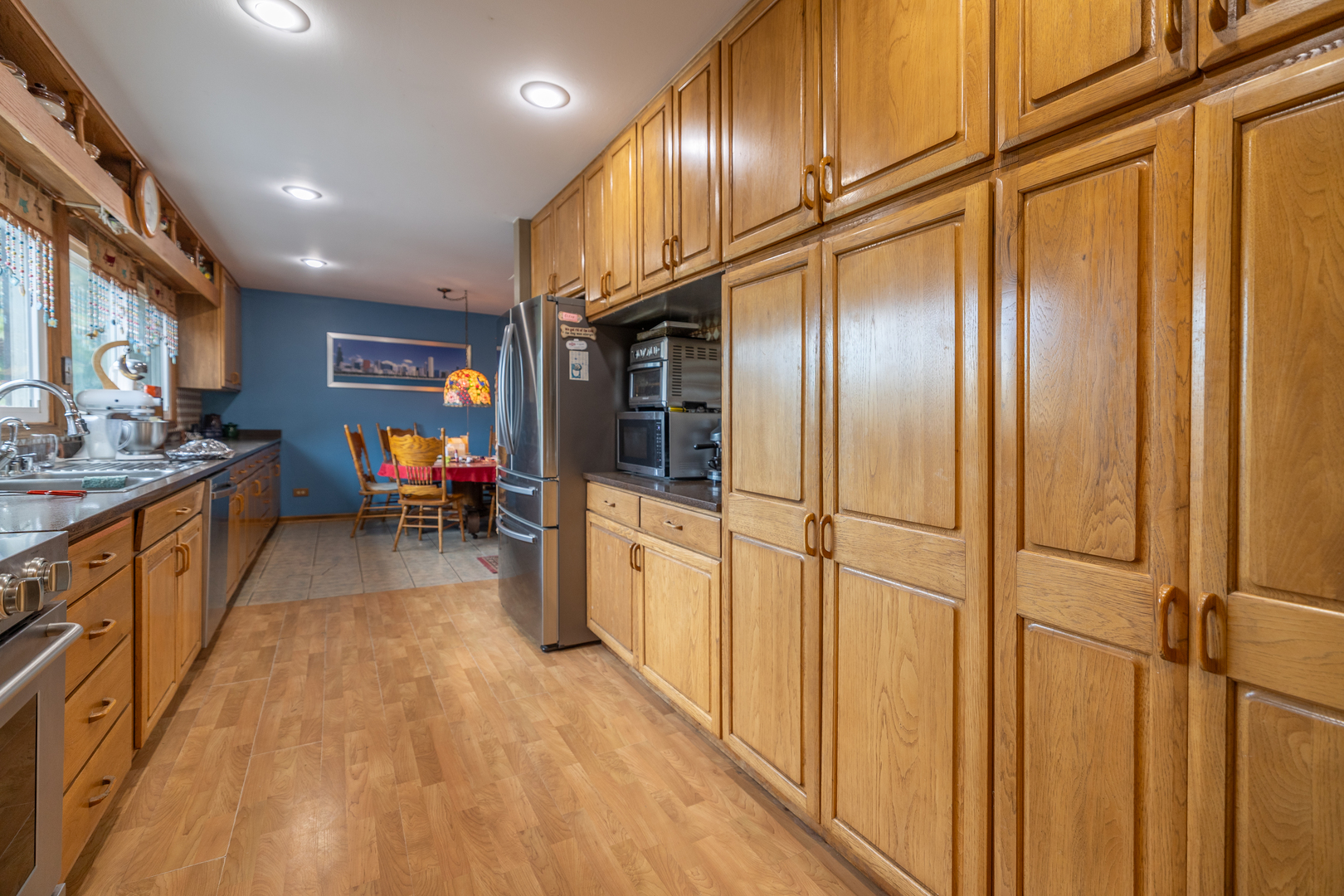 15534 Somonauk Road DeKalb, IL 60115 - Photo 11 of 48 a kitchen with stainless steel appliances granite countertop a refrigerator a stove and a wooden floors
