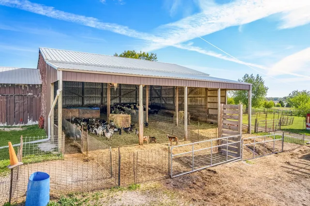 a picture of a bathroom with a tub sink and mirror
