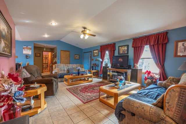 a kitchen with stainless steel appliances granite countertop a refrigerator a stove and a wooden floors