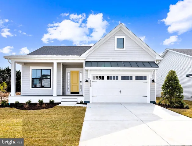 a view of a white house with a yard in front of it