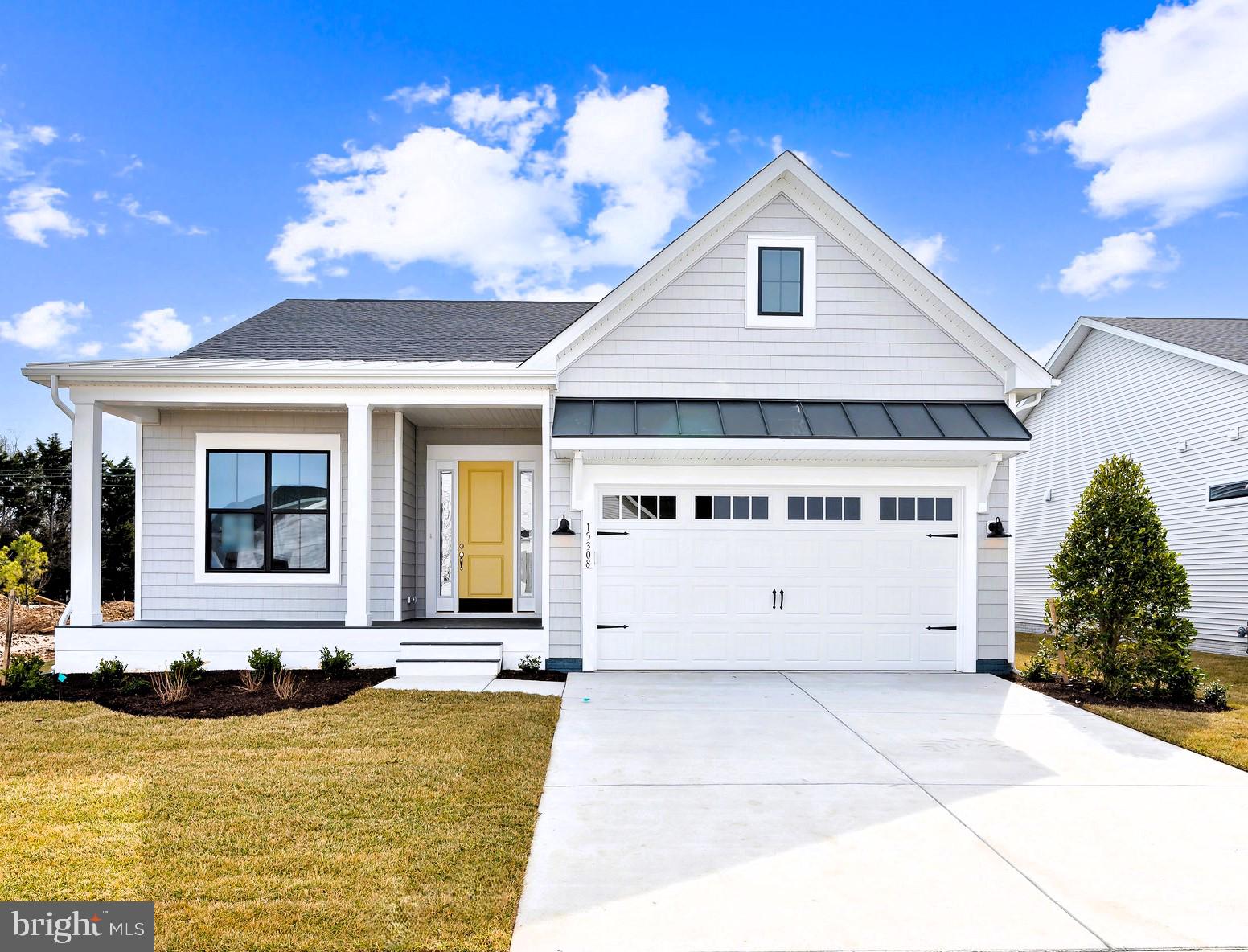 a view of a white house with a yard in front of it
