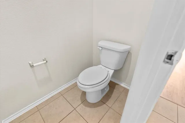 a white toilet sitting next to a white cabinet