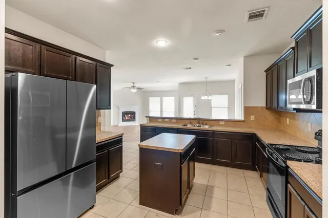 a kitchen with a refrigerator sink and stove