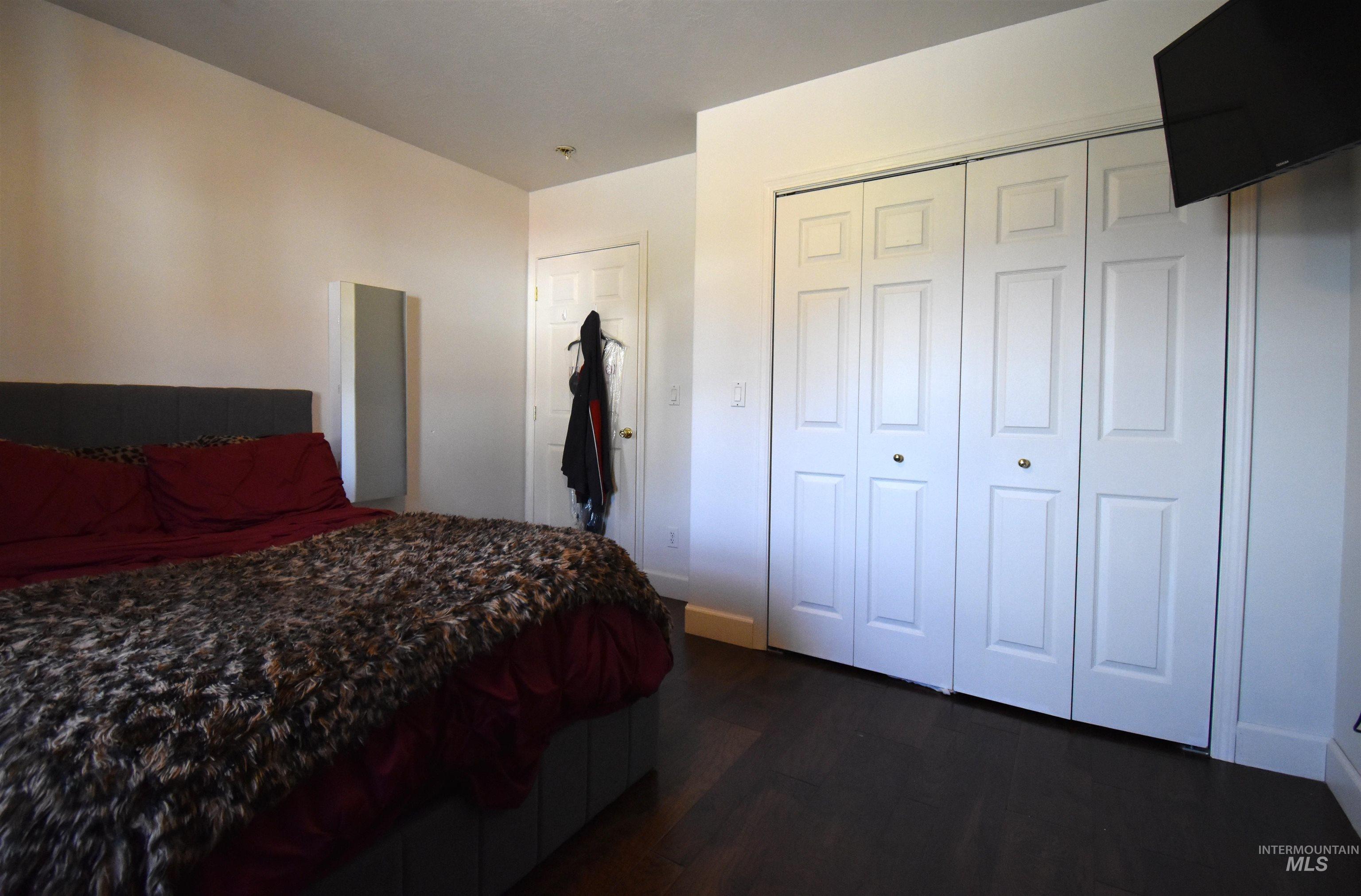 2599 Fruitvale Glendale Road Council, ID 83612 - Photo 14 of 38 Bedroom with dark wood-type flooring and a closet