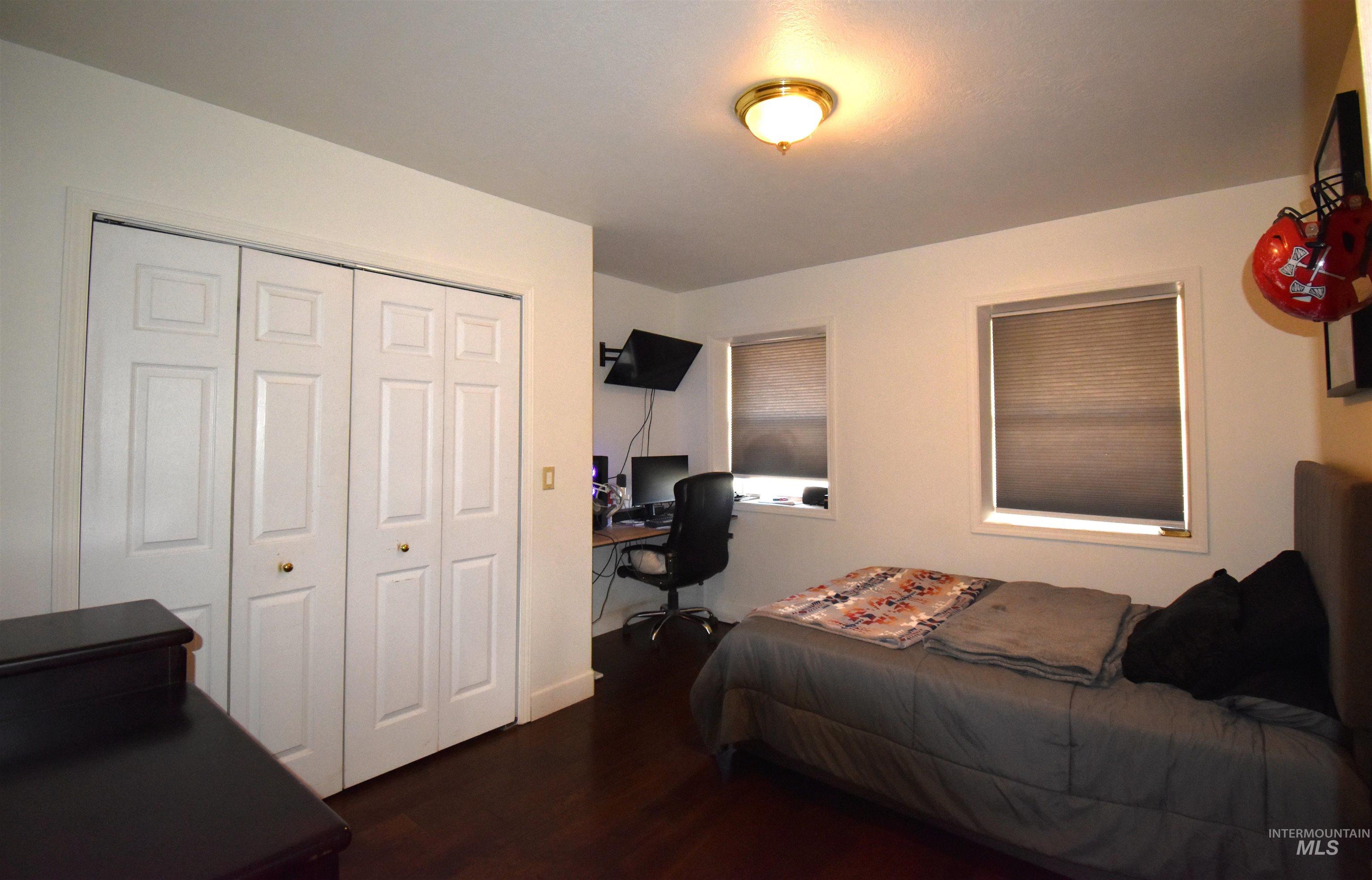 2599 Fruitvale Glendale Road Council, ID 83612 - Photo 21 of 29 Bedroom with a desk, dark wood-style floors, and a closet