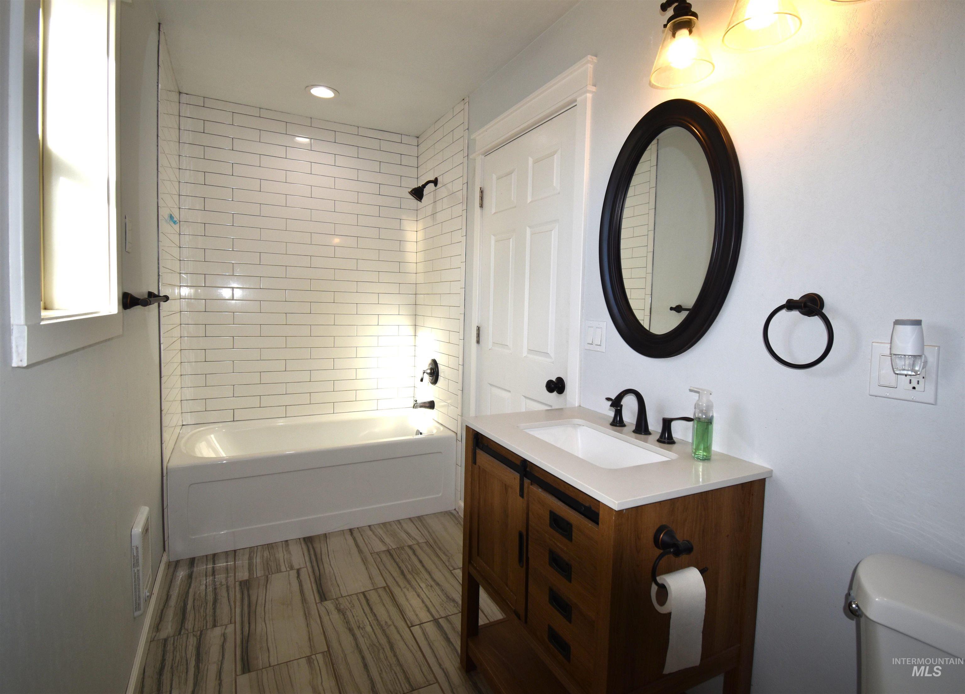 2599 Fruitvale Glendale Road Council, ID 83612 - Photo 26 of 38 Bathroom with vanity, bathtub / shower combination, and recessed lighting.